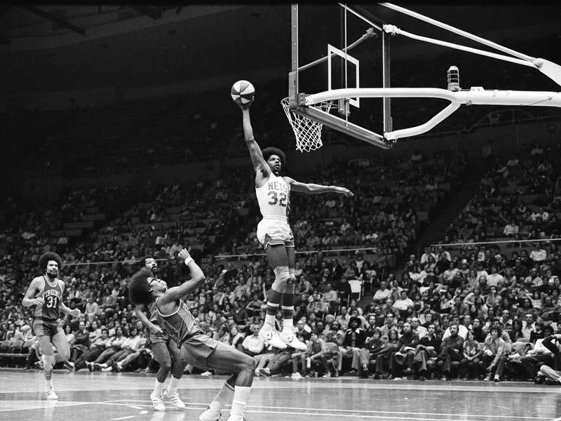 Julius Erving scores during ABA game