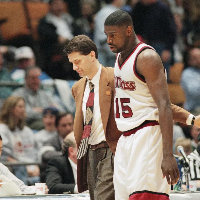 Massachusetts coach John Calipari and Lou Roe walk to bench