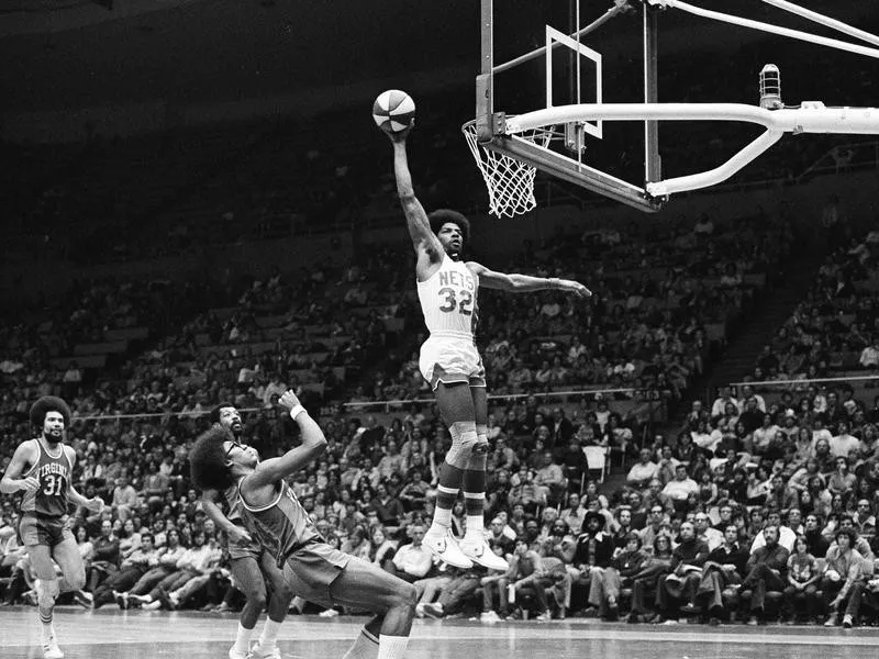 New York Nets' Julius Erving scores