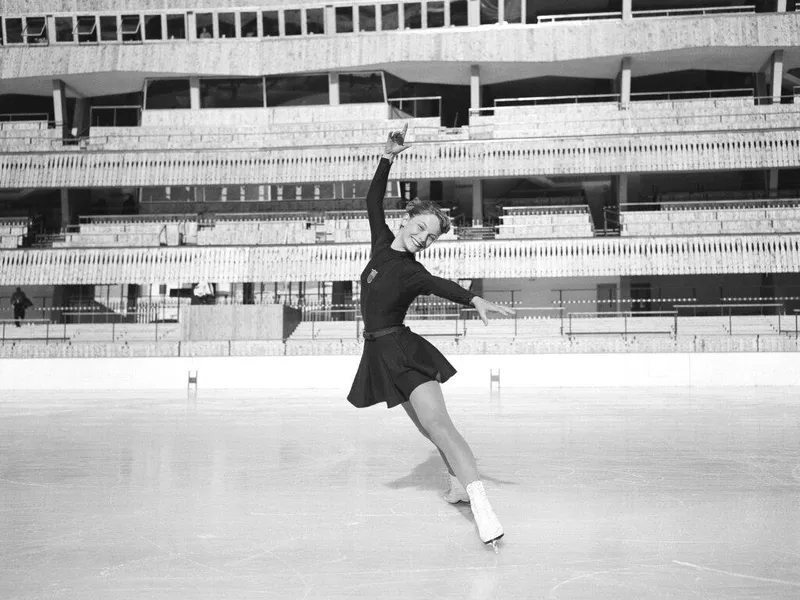 Carol Heiss smiling at the ice rink