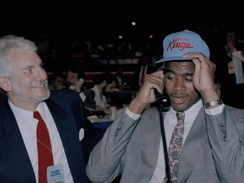 Pervis Ellison smiles as he's drafted with Sacramento Kings hat on