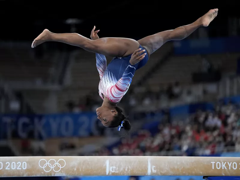 Simone Biles performs on the balance beam