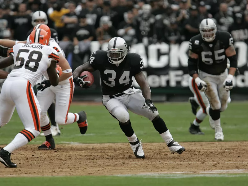 LaMont Jordan runs for yardage against Cleveland Browns