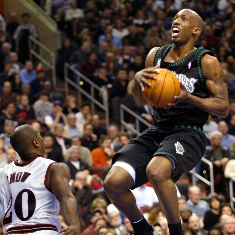 Minnesota Timberwolves' Chauncey Billups goes up against Philadelphia 76ers' Eric Snow