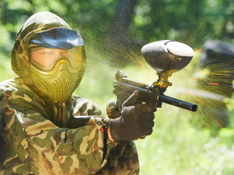 Paintball player being hit with paintball