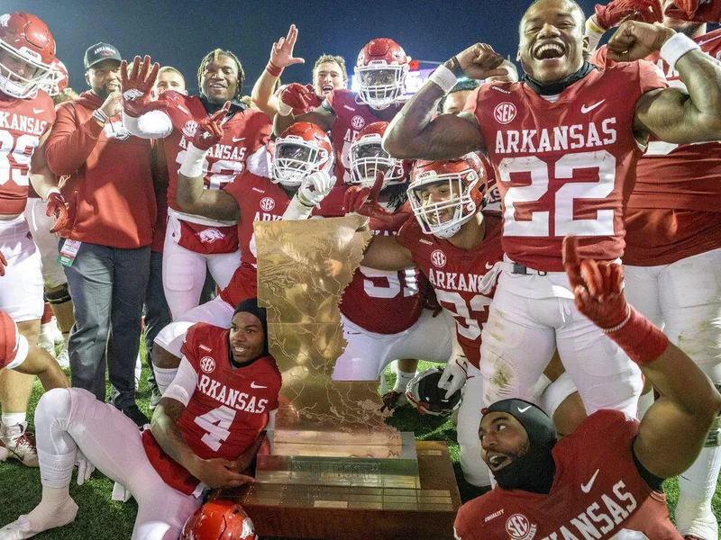 Arkansas team with golden boot trophy