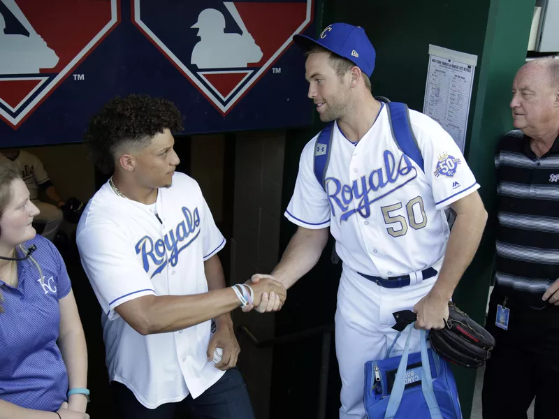 Kansas City Chiefs quarterback Patrick Mahomes greeted by Kansas City Royals pitcher Jason Adam