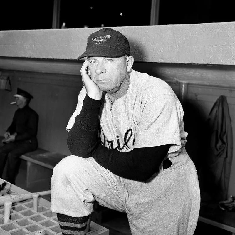 Manager Jimmy Dykes sitting in dugout