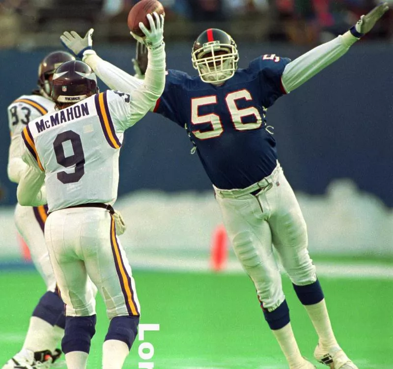 r Lawrence Taylor pressures Minnesota Vikings quarterback Jim McMahon