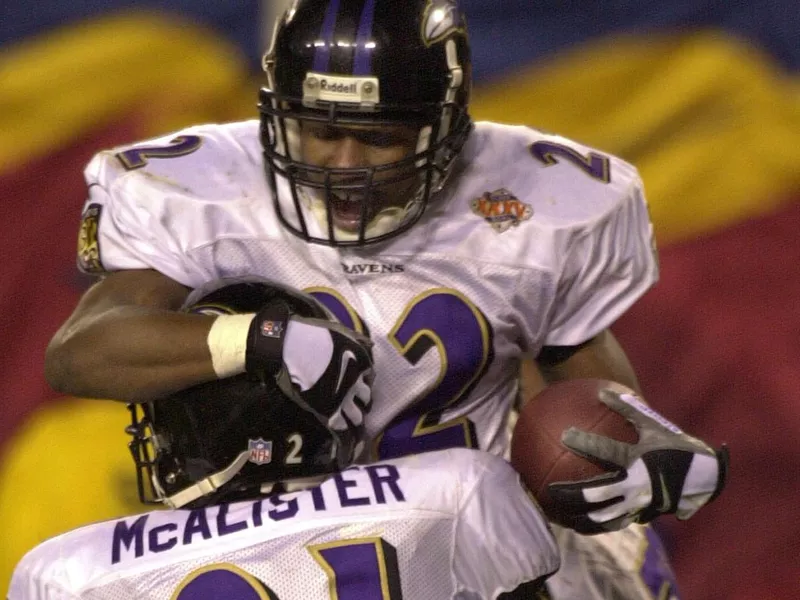 Baltimore Ravens defensive back Duane Starks hoisted by teammate Chris McAlister