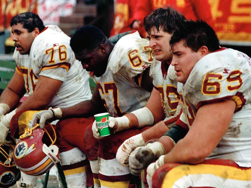 Washington Redskins offensive lineman Mark Schlereth (No. 69) with teammates on the bench