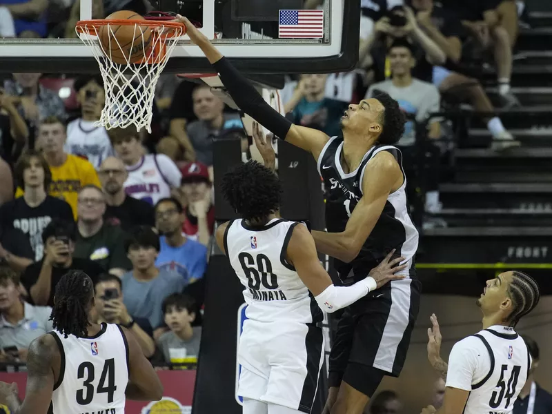 Victor Wembanyama dunks over Portland Trail Blazers' Justin Minaya