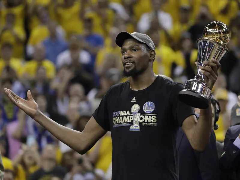 Kevin Durant holds Bill Russell NBA Finals Most Valuable Player Award