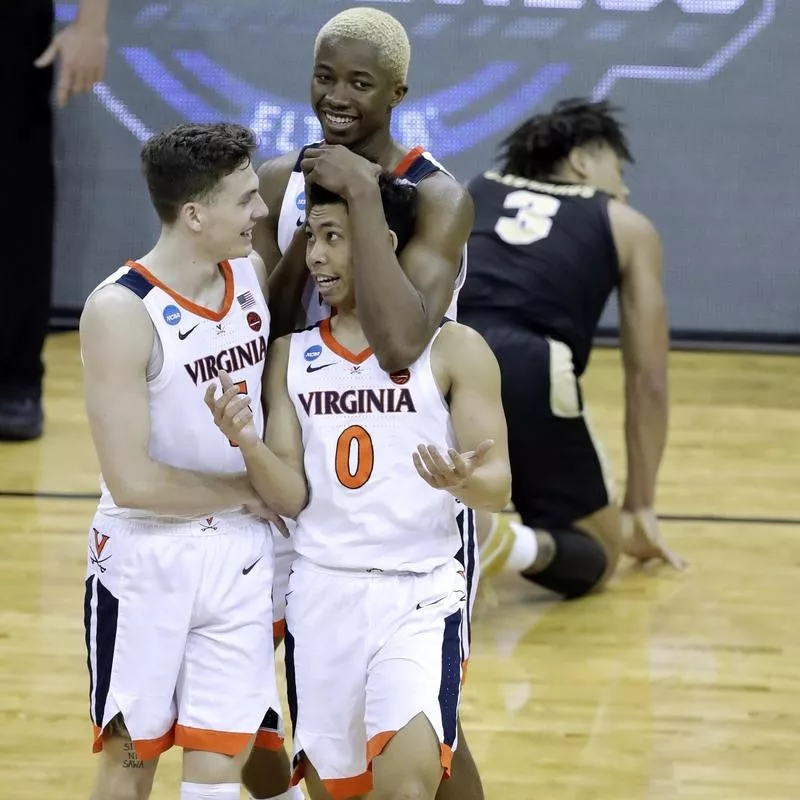 Mamadi Diakite of Virginia celebrates with teammates during overtime