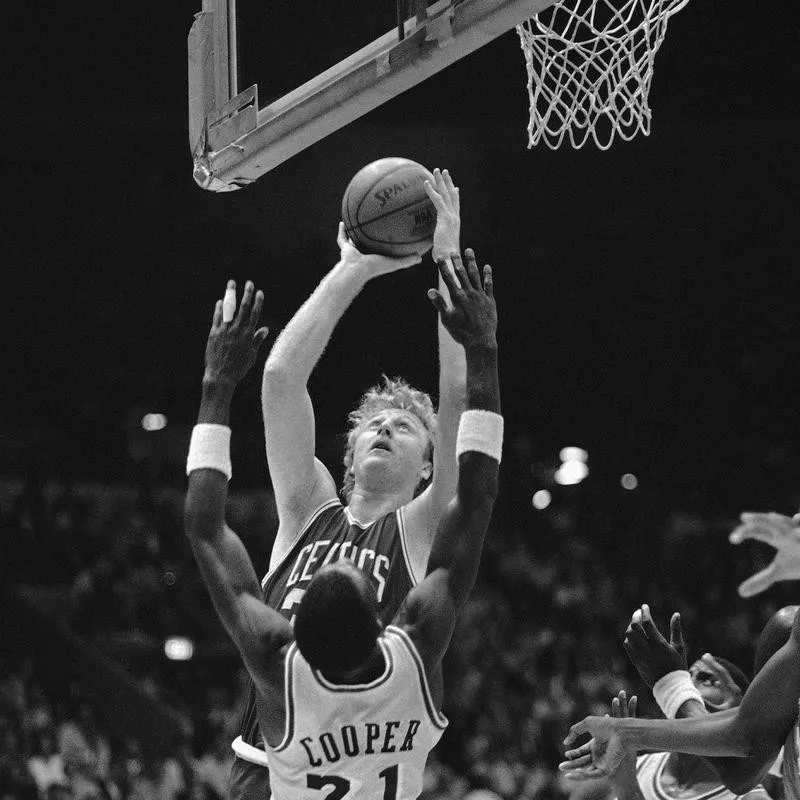 Larry Bird drives to basket