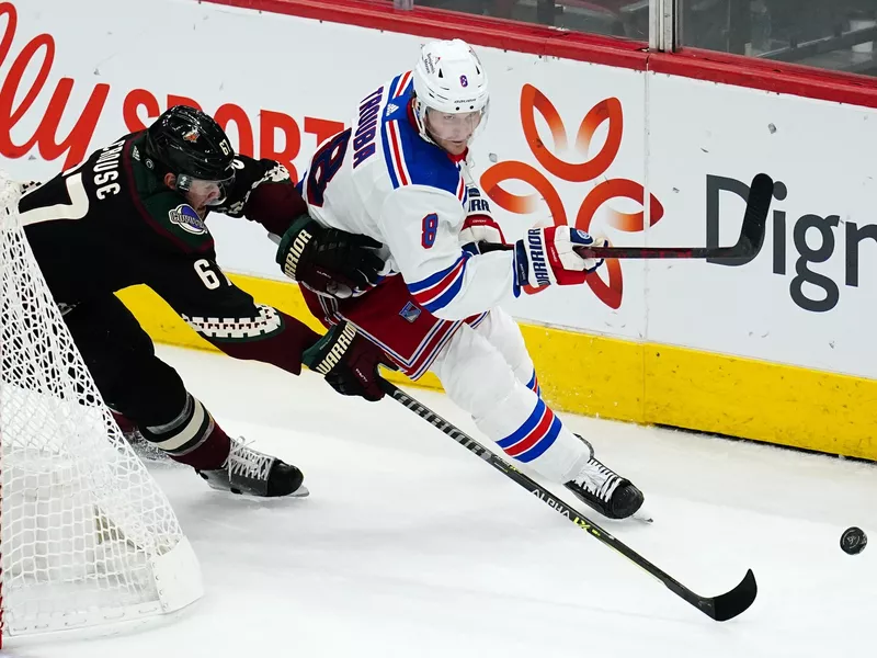 New York Rangers defenseman Jacob Trouba skates against Lawson Crouse