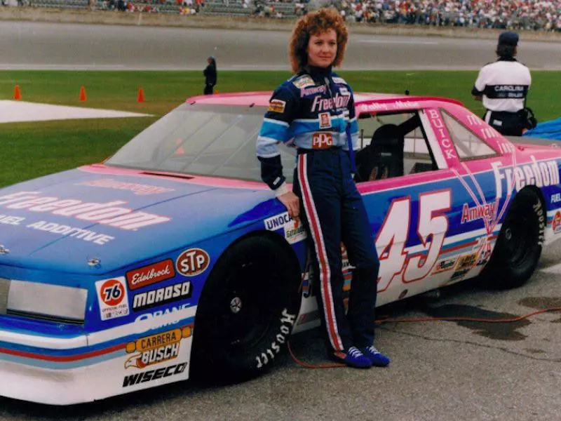 Patty Moise poses by car