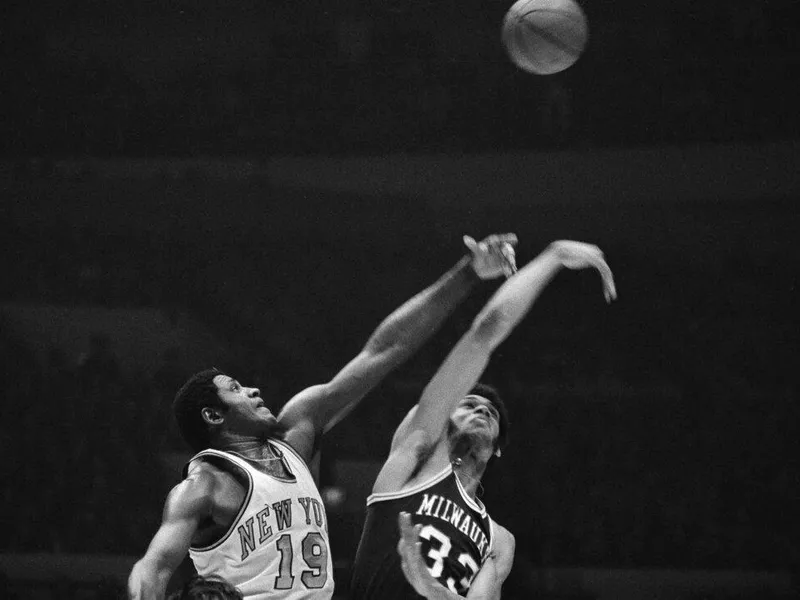 Willis Reed and Kareem Abdul-Jabbar vie for the ball