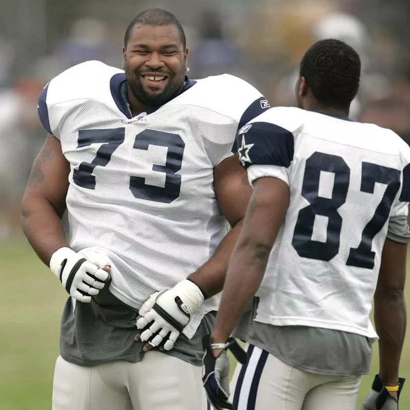 Dallas Cowboys guard Larry Allen shares a laugh with Zuriel Smith