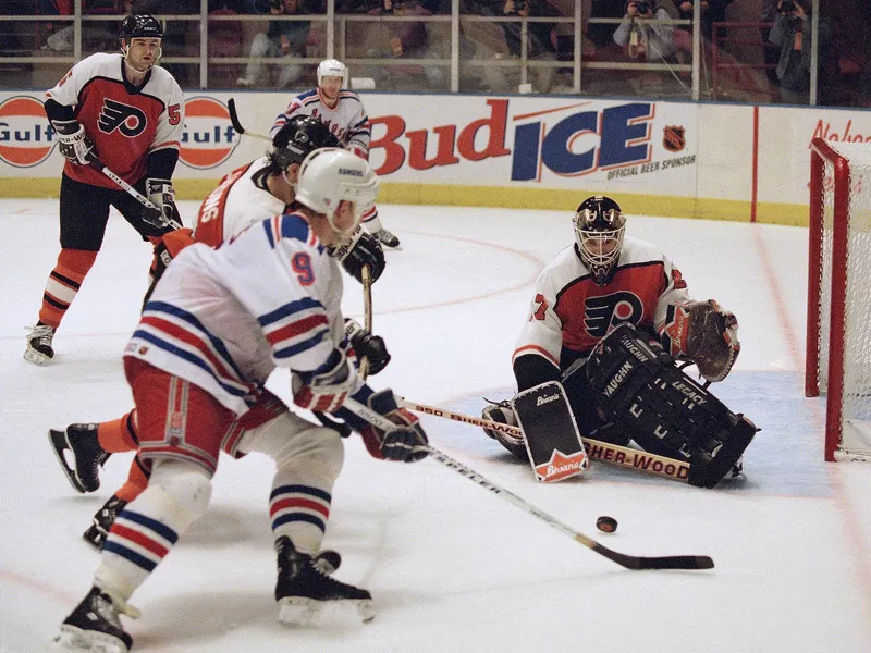 Philadelphia Flyers goalie Ron Hextall blocks shot on goal by Adam Graves