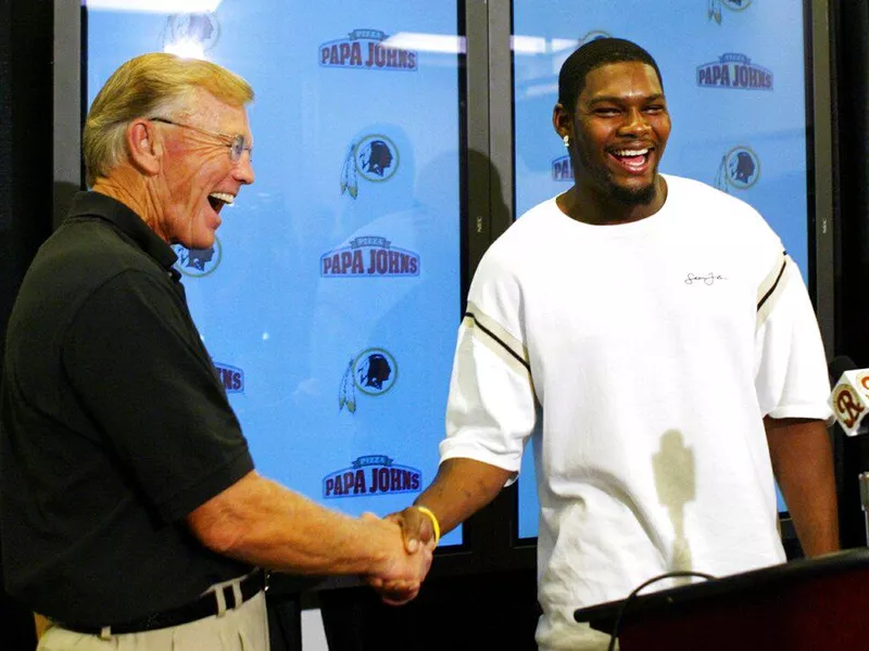 Sean taylor shakes hands with joe gibbs