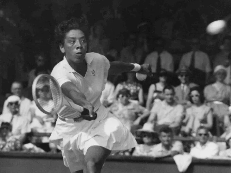 Althea Gibson hitting a volley on the tennis court