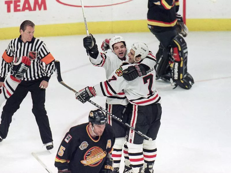 Chicago Blackhawks' Joe Murphy celebrates with teammate Chris Chelios after Murphy's overtime goal