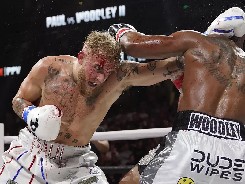 Jake Paul hits Tyron Woodley with punch