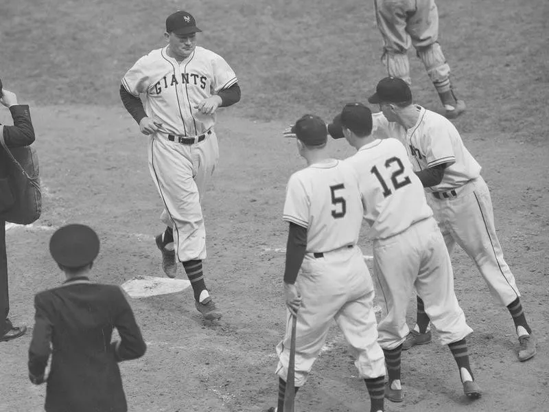 Johnny Mize crosses home plate