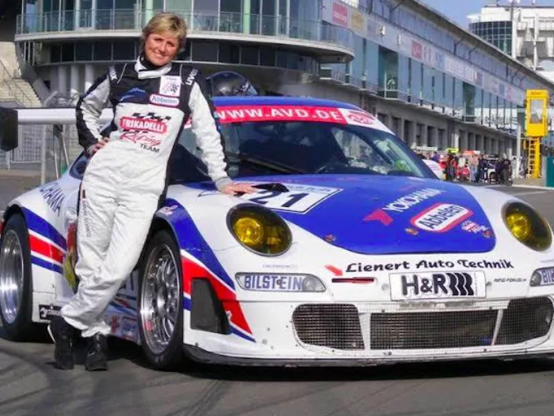 Sabine Schmitz poses by car