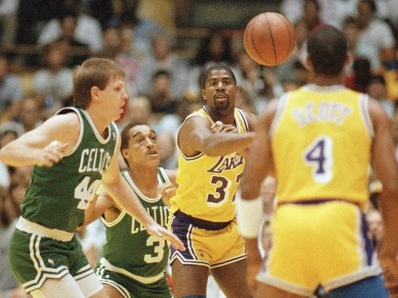 Earvin Johnson passes to Byron Scott