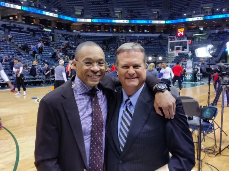 Gus Johnson smiling on the court