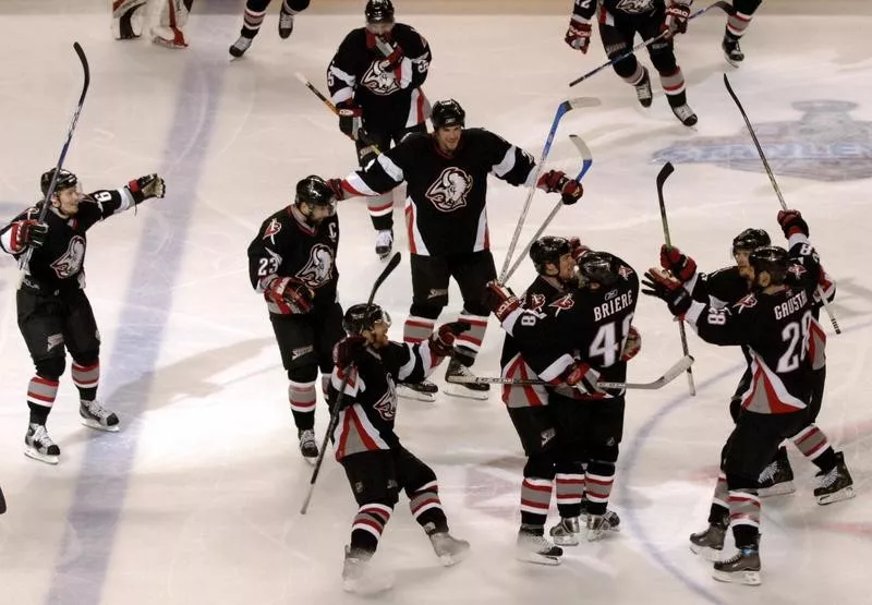 Buffalo Sabres celebrate with Daniel Briere after scoring game-winning overtime goal