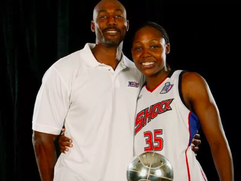 Cheryl Ford posing with Karl Malone