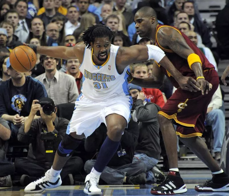 Denver Nuggets Nene drives around Cleveland Cavaliers Antawn Jamison