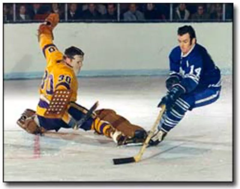 Dave Keon skates with puck