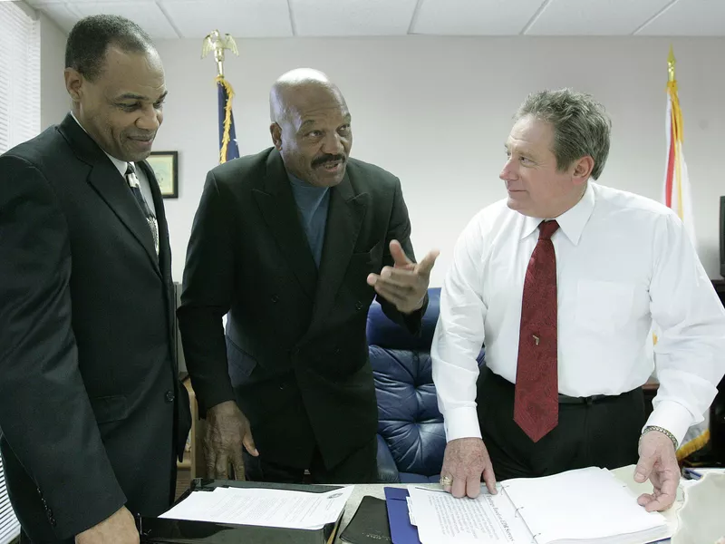 Jim Brown with Rep. Mitch Needelman, right, and Walt McNeil, left