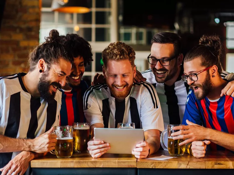 Friends watching football game at the pub