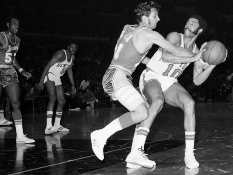 Johnny Egan puts pressure on Walt Frazier