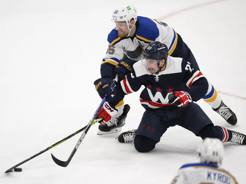 Colton Parayko and Conor Sheary compete for puck