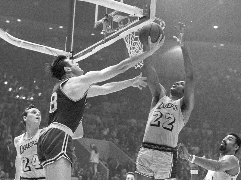 Elgin Baylor blocks shot by Bailey Howell