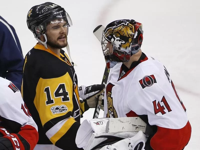 Chris Kunitz of the Pittsburgh Penguins and Craig Anderson of the Ottawa Senators meet in handshake line