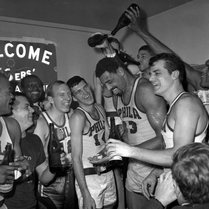 Philadelphia 76ers Wilt Chamberlain gets champagne poured on him