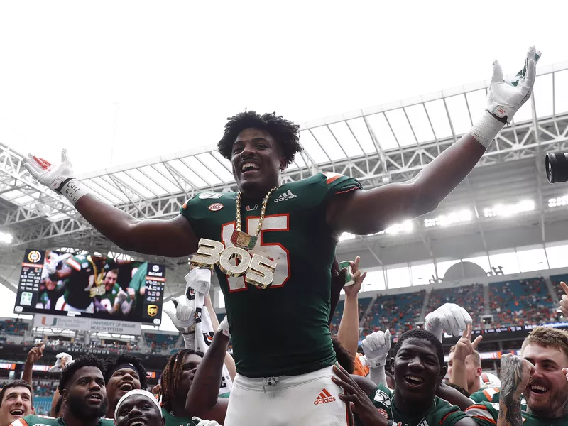 Miami defensive lineman Gregory Rousseau celebrates turnover