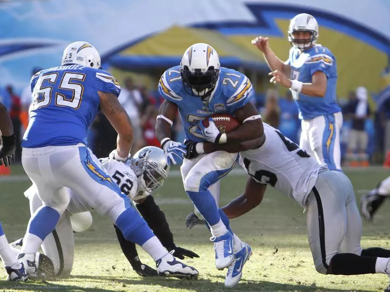 LaDainian Tomlinson carries against Oakland Raiders