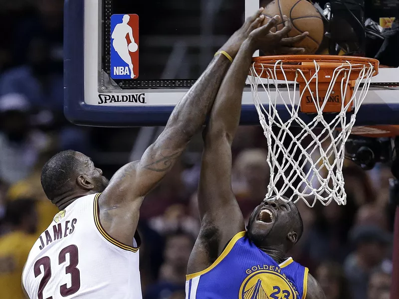 LeBron James drives on Draymond Green