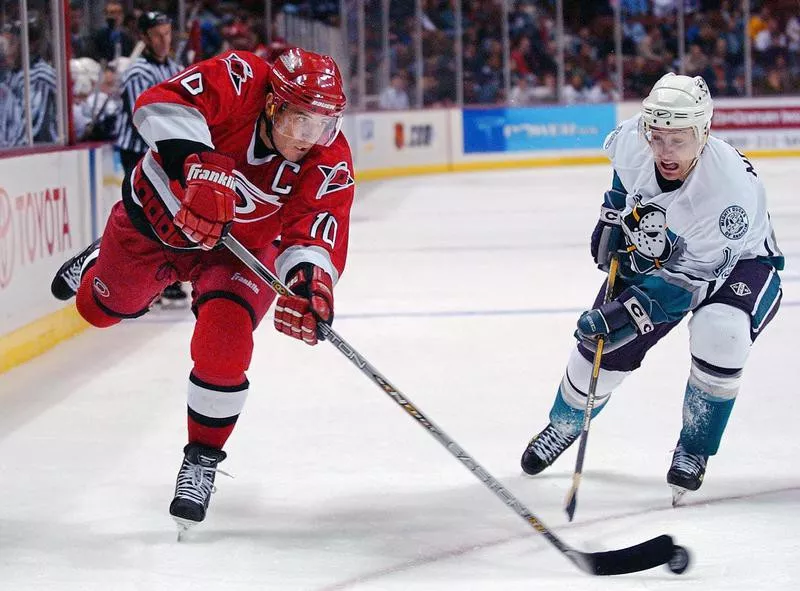 Carolina Hurricane Ron Francis passes the puck against the Anaheim Mighty Ducks