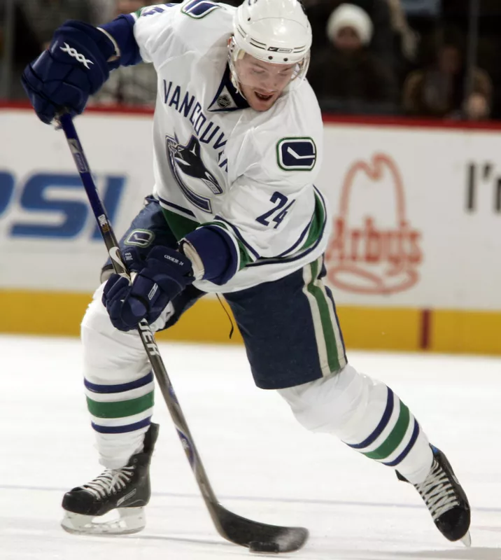 Vancouver Canucks left winger Matt Cooke moves puck up ice