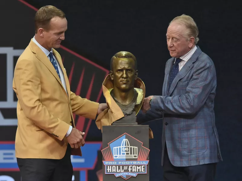 Peyton Manning with his bust