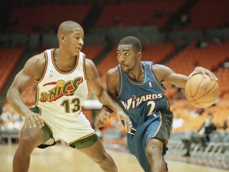 Washington Wizards God Shammgod works around Seattle Supersonics Eric Snow